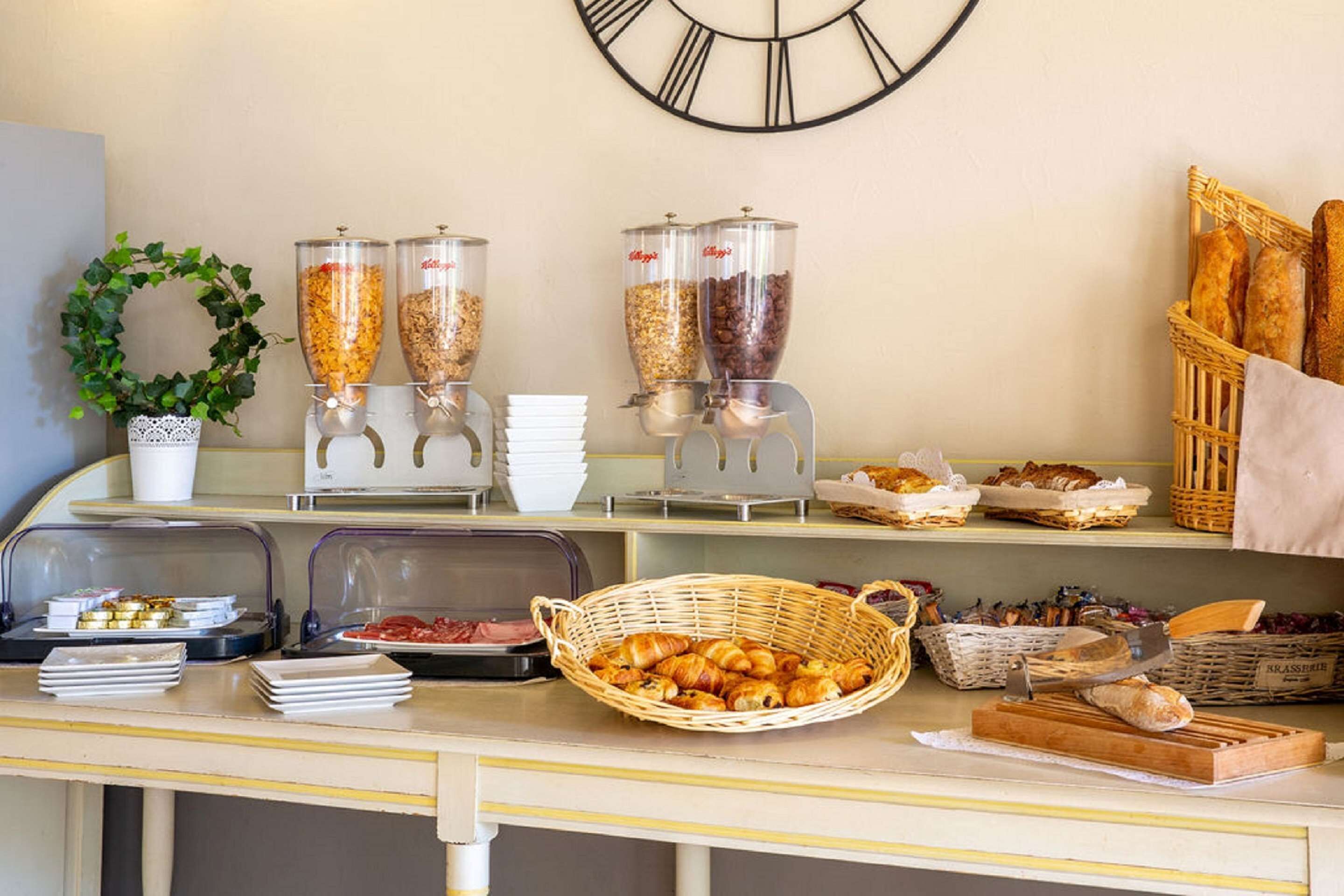 A buffet setup with various food items and serving equipment.