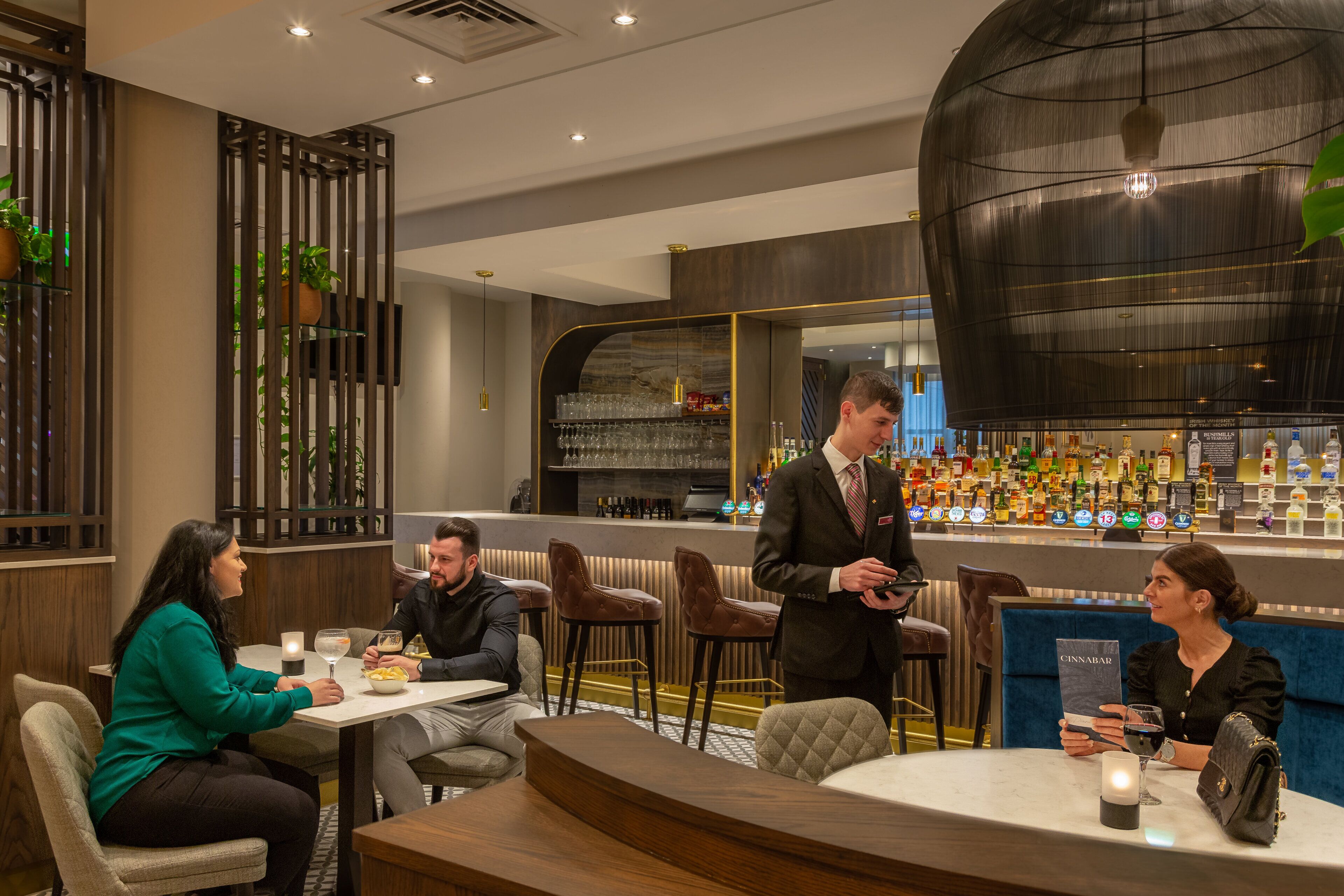 A modern bar area with seating and a bar counter.