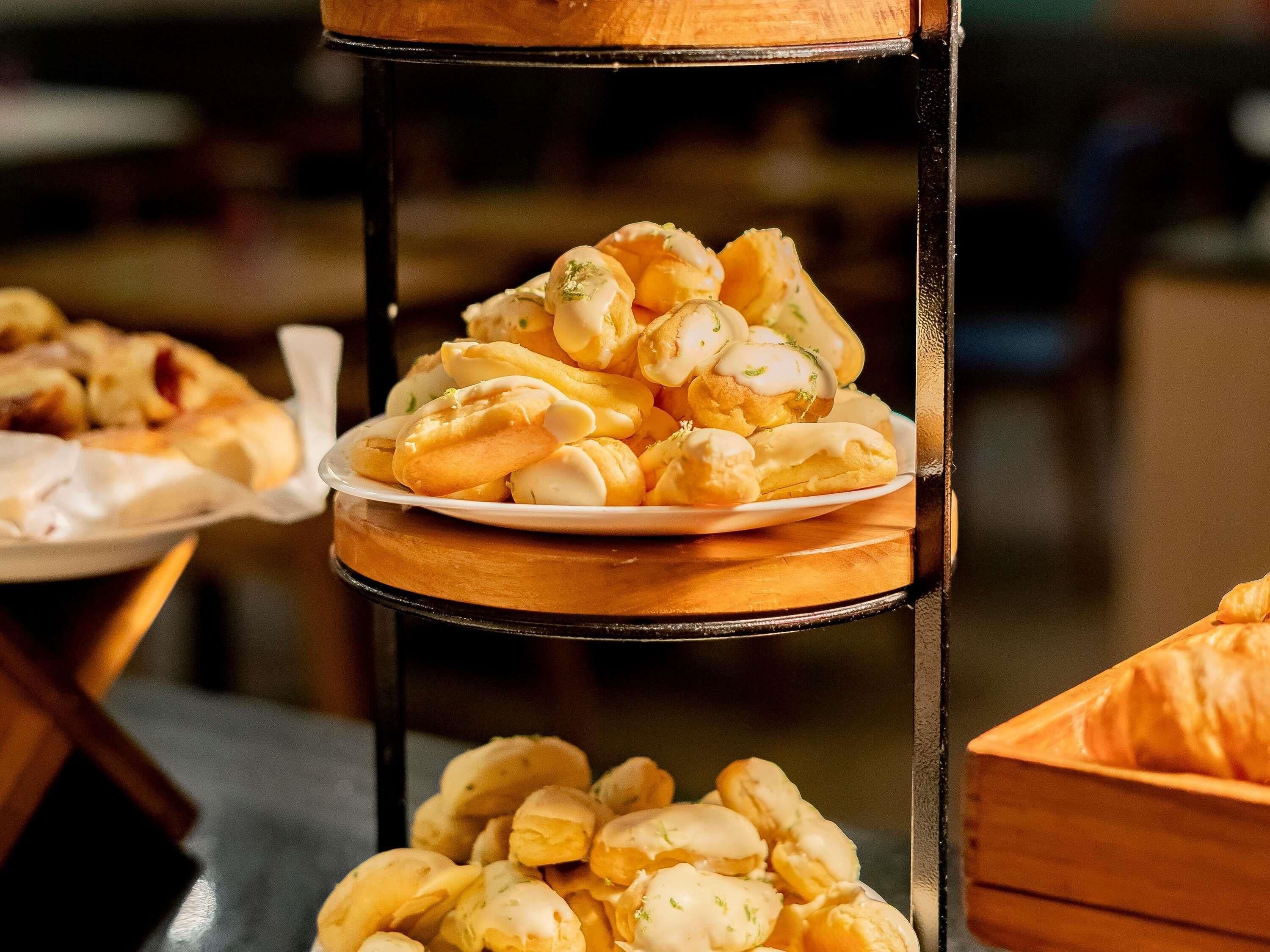 A multi-tiered display stand with various pastries.