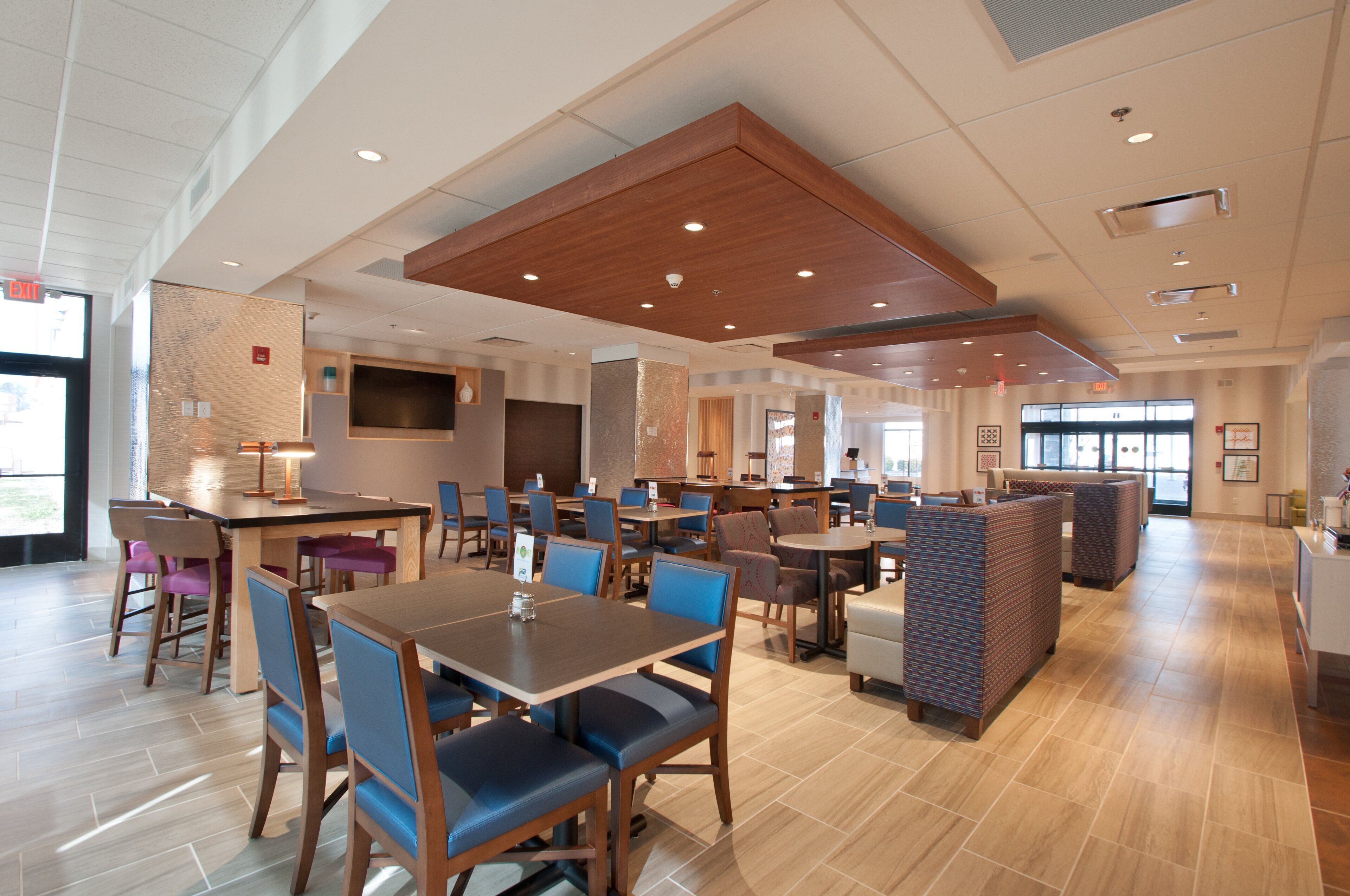 A spacious restaurant with multiple dining areas, including booths and tables.