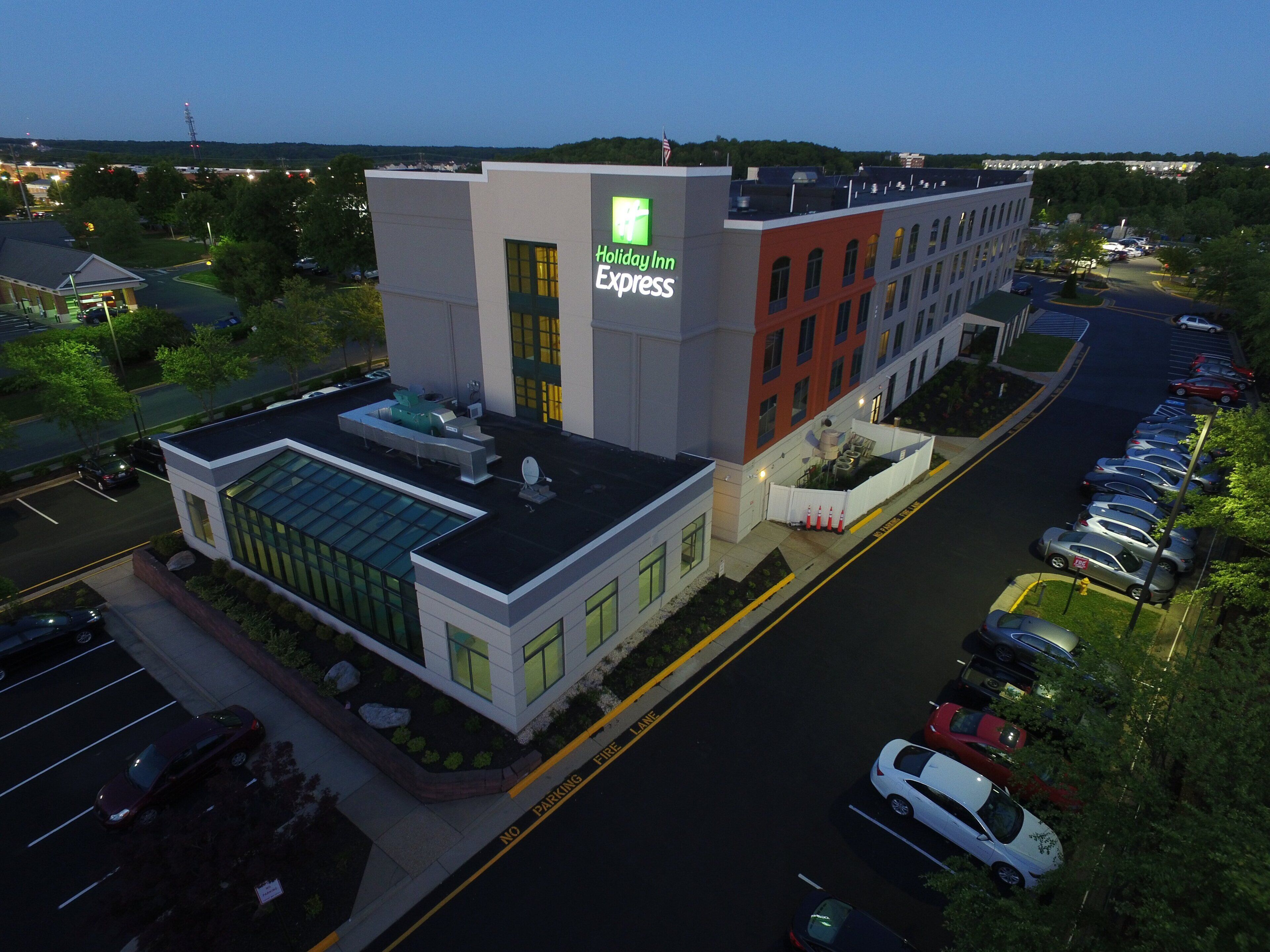 A Holiday Inn Express hotel with a parking lot and a road in front.