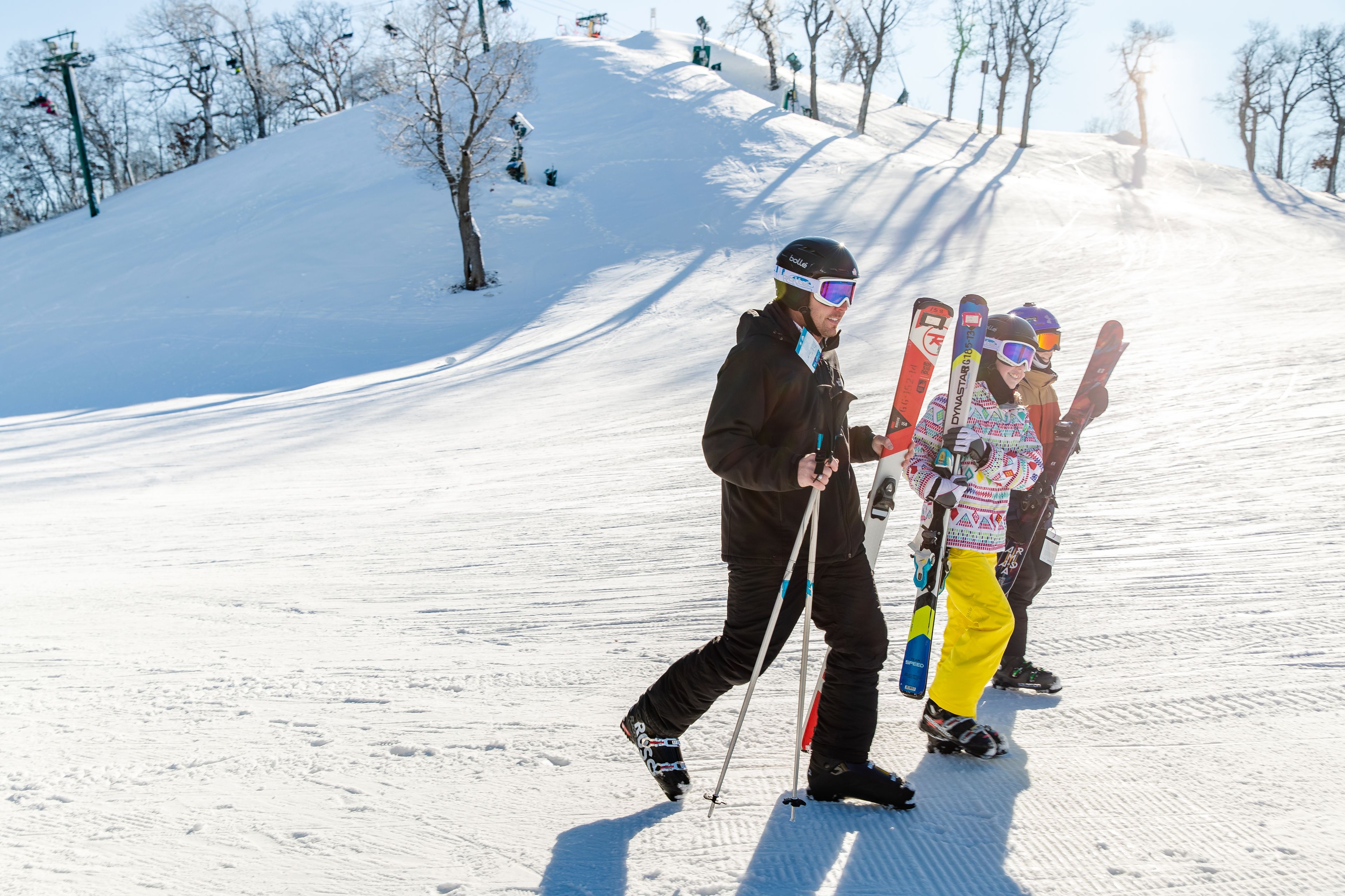 A snowy ski slope with skiers.