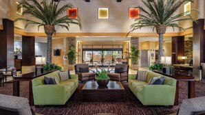 A spacious lobby with green sofas, a coffee table, and two palm trees. There are chairs and a reception desk in the background. - The Westin Kierland Villas, Scottsdale (Scottsdale)