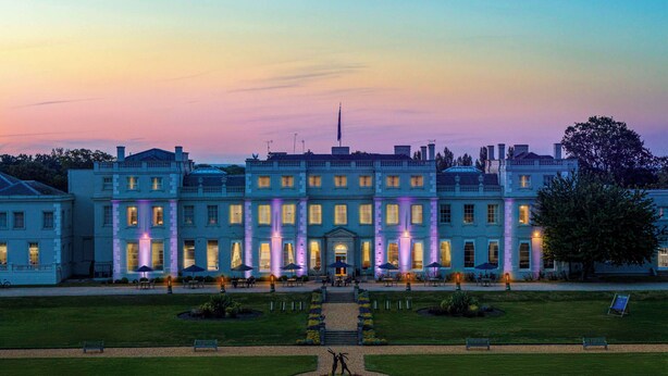 A large, historic building with a symmetrical facade, multiple windows, and a central entrance. - De Vere Wokefield Estate (Reading)