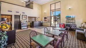 A spacious lobby with a reception desk, seating area, and large windows offering views. - Americas Best Value Inn & Suites Arkadelphia (Arkadelphia)