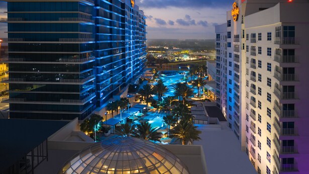 A hotel with multiple floors, a swimming pool area, and a dome structure.