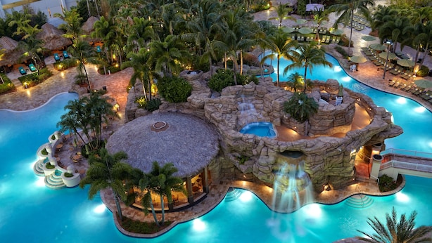 A resort with a large central pool, multiple smaller pools, and a waterfall feature.