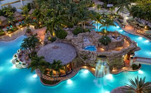 A resort with a large central pool, multiple smaller pools, and a waterfall feature. - Seminole Hard Rock Hotel and Casino (Hollywood)