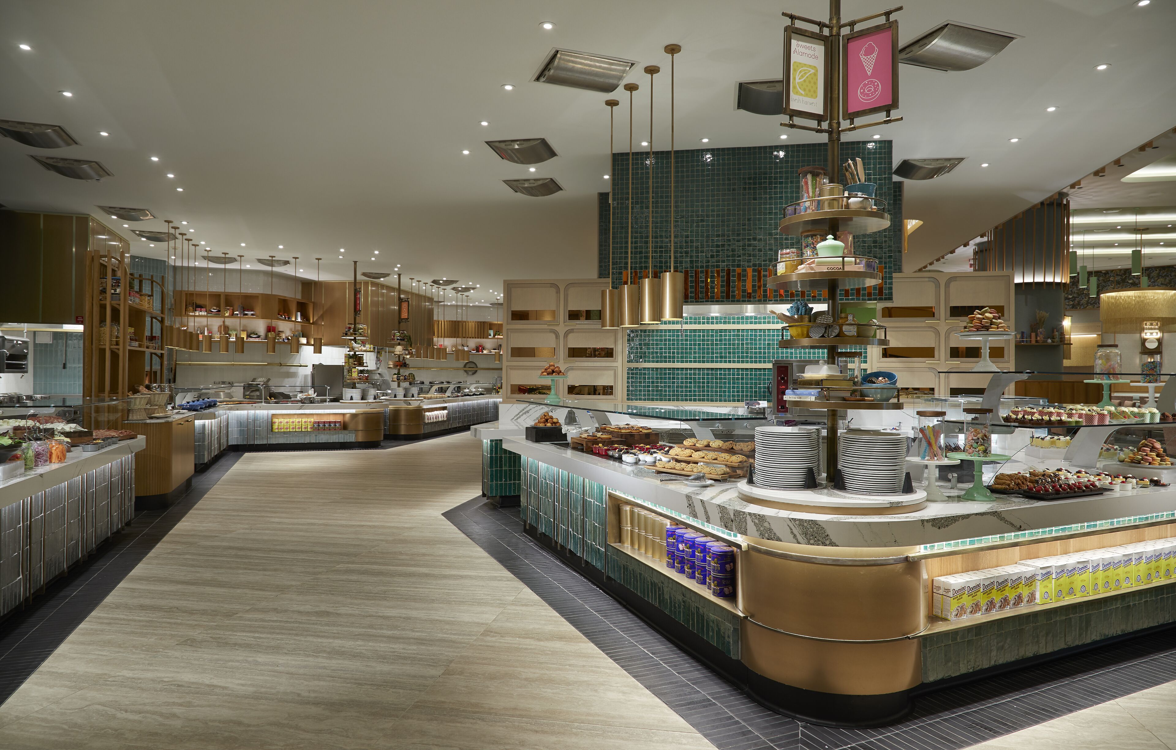 A modern breakfast buffet with various food stations and a clean, well-lit interior.