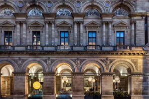 Experience the blend of history and modern functionality in this historic building with ornate sculptures and detailed architecture.