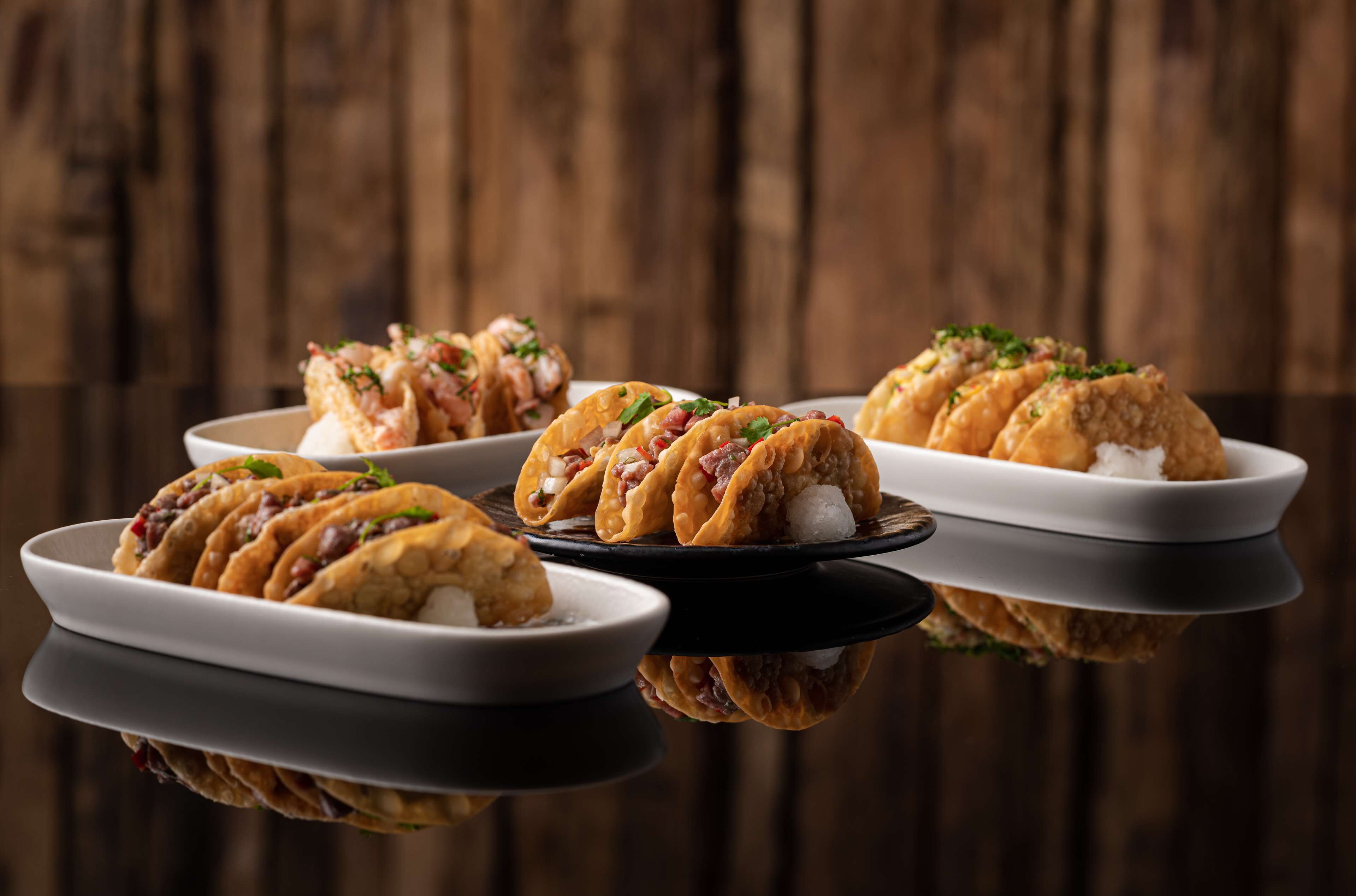 Three plates of food with a wooden background.