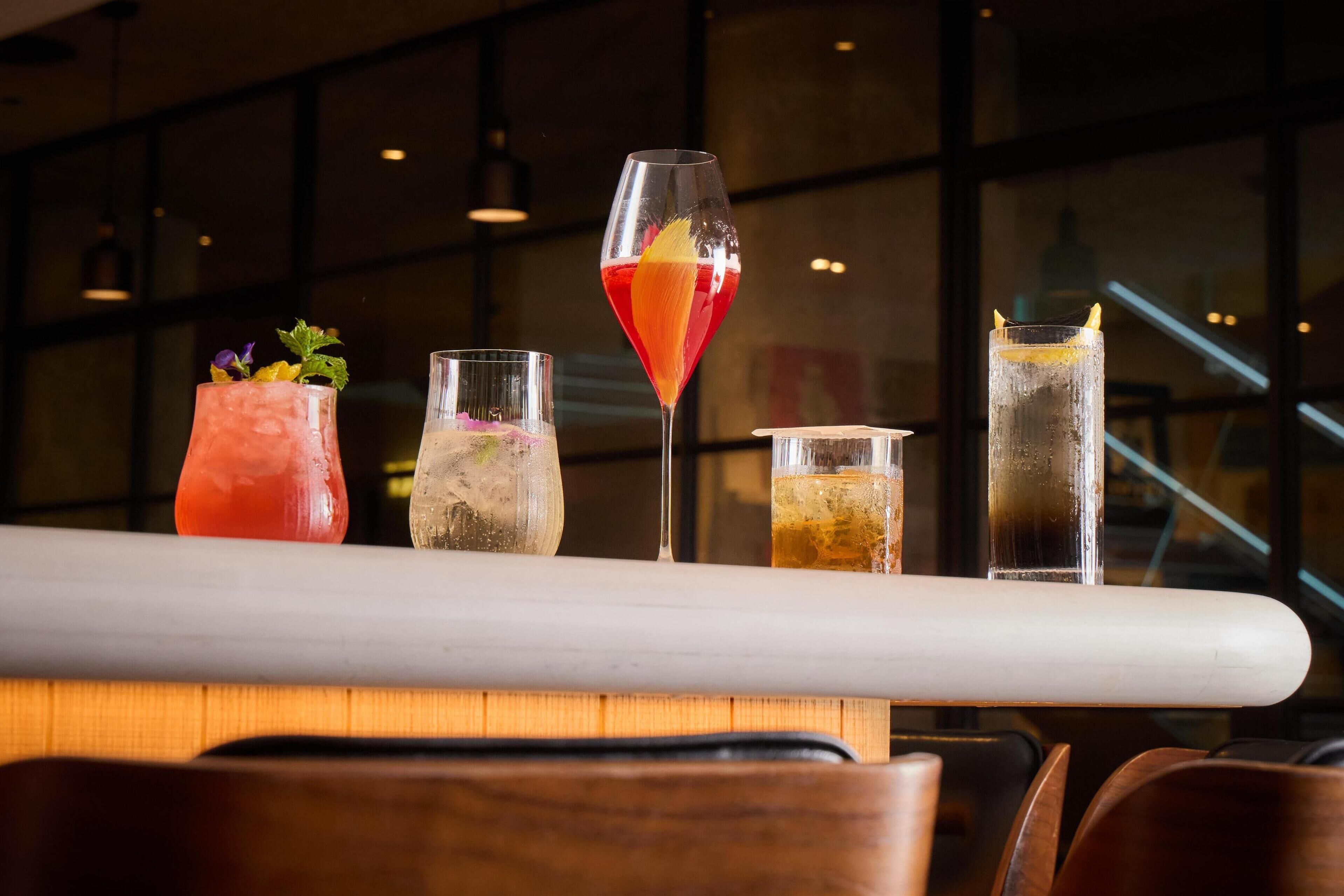 A bar area with various drinks and a modern interior.