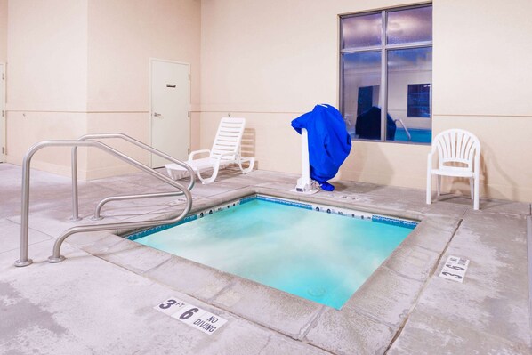 A swimming pool with a 3 ft depth marker, a 6 ft no diving sign, and a window with a view of the pool.