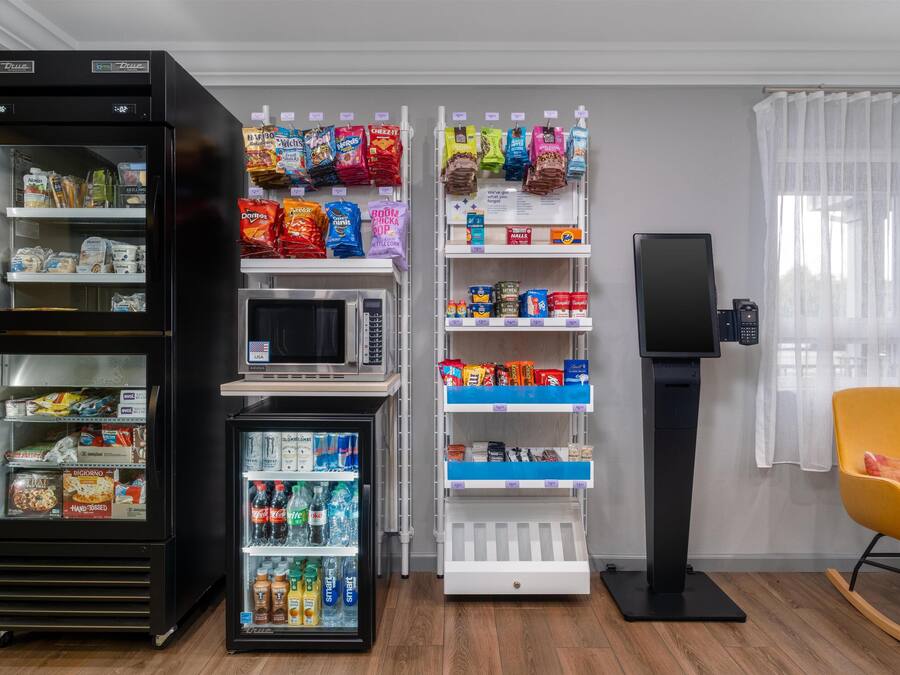 Un distributeur automatique proposant des collations, des boissons et un four à micro-ondes.