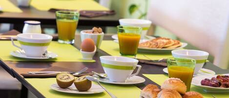A breakfast buffet with various food items and beverages.