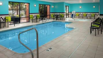 Relax by the pool surrounded by comfortable lounge chairs and enjoy the view from the windows.