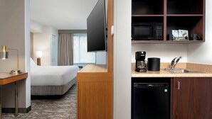 A hotel room with a bed, a desk, a TV, a microwave, a coffee maker, and a dishwasher. - SpringHill Suites by Marriott Portland Hillsboro (Hillsboro)