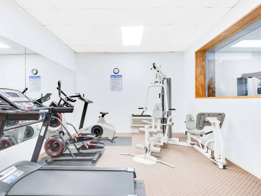 A gym with treadmills, stationary bikes, and weight machines.