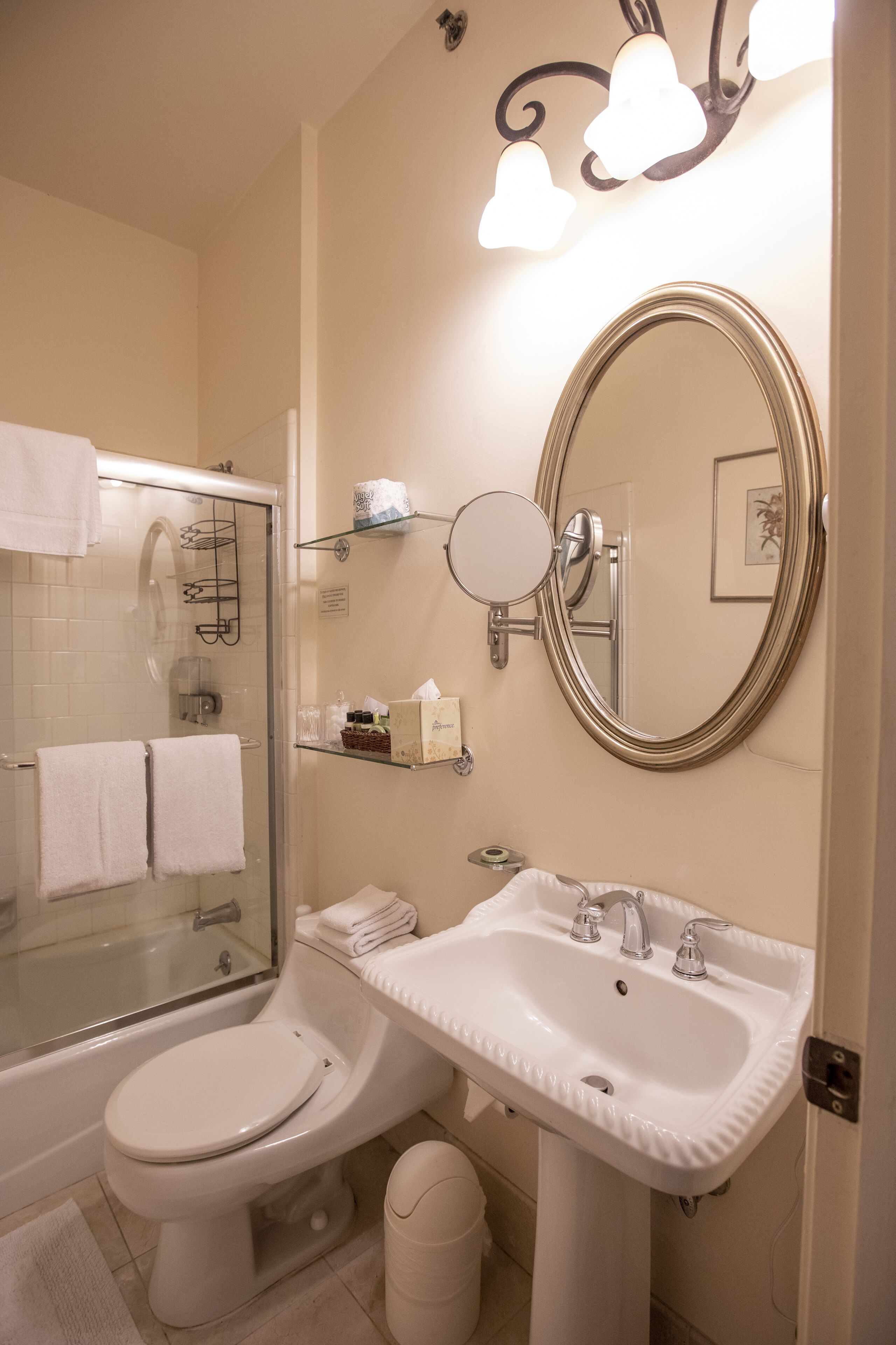 A bathroom with a toilet, sink, and shower.