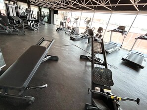 A gym with various exercise equipment, including treadmills and weight machines.