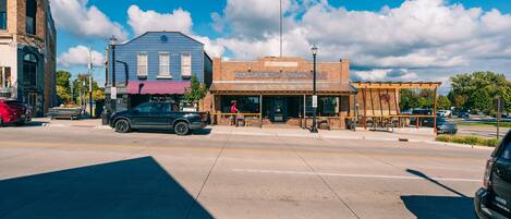 A street view with a building labeled "SAVERS BREWING COMPANY" and a parked truck.