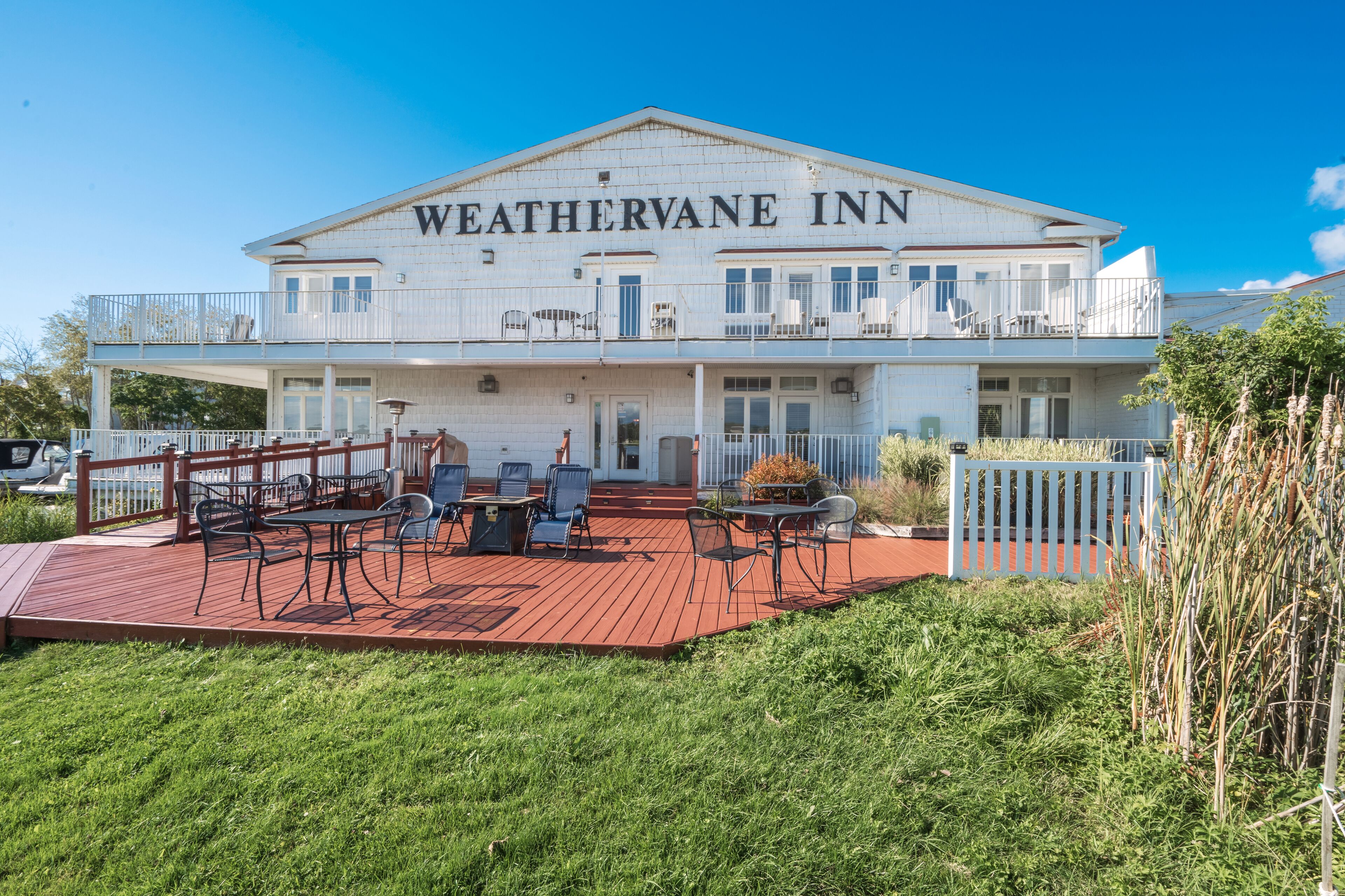 A two-story building with the name "WEATHERVANE INN" on the facade.