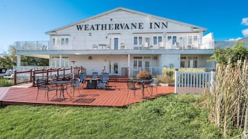 A two-story building with the name "WEATHERVANE INN" on the facade.