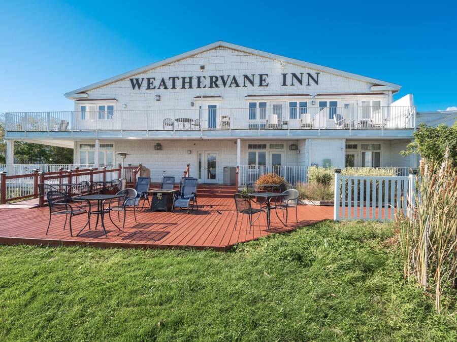 A two-story building with the name "WEATHERVANE INN" on the facade.