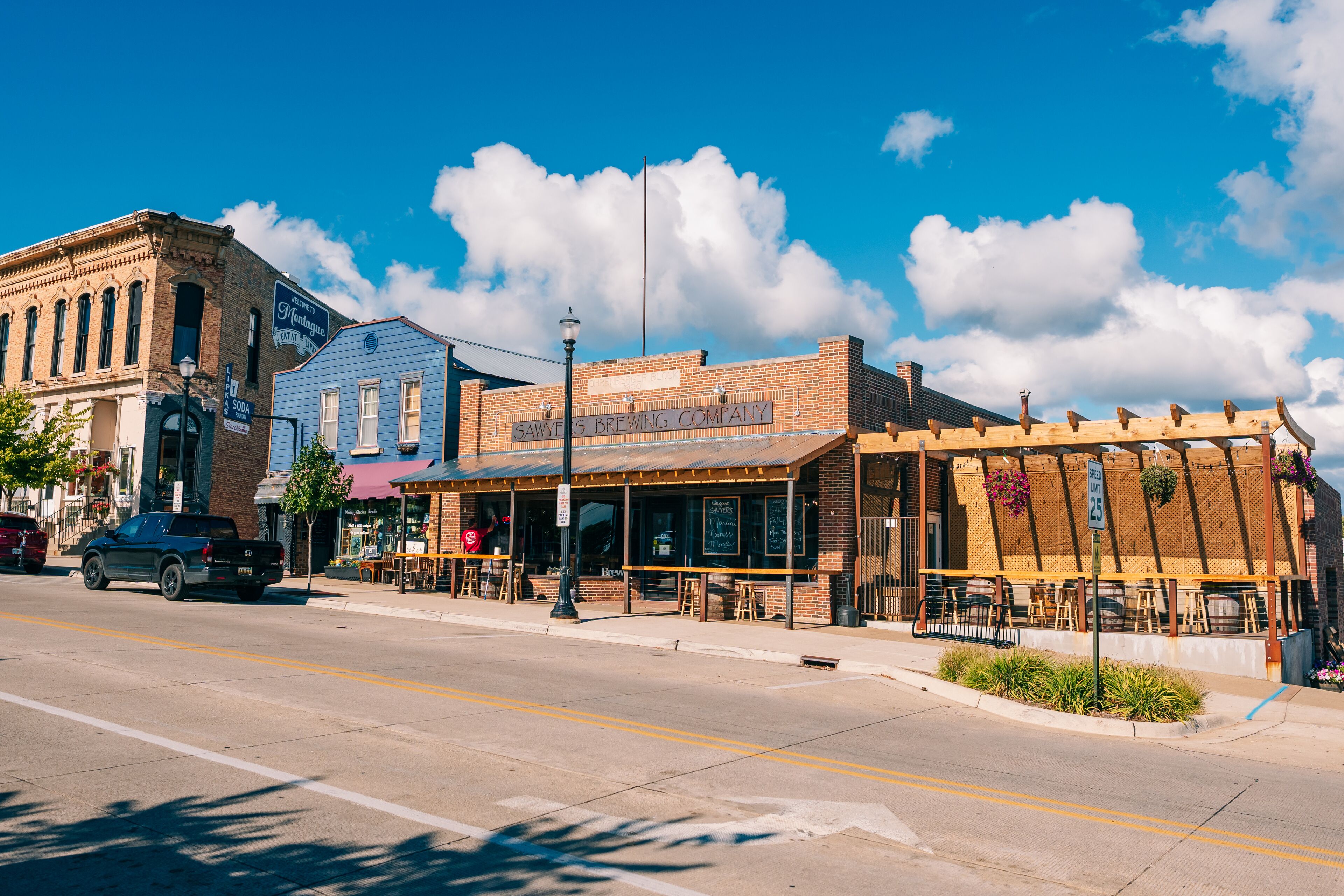 A street view with a building labeled "Sawyers Brewing Company" and a parked car.