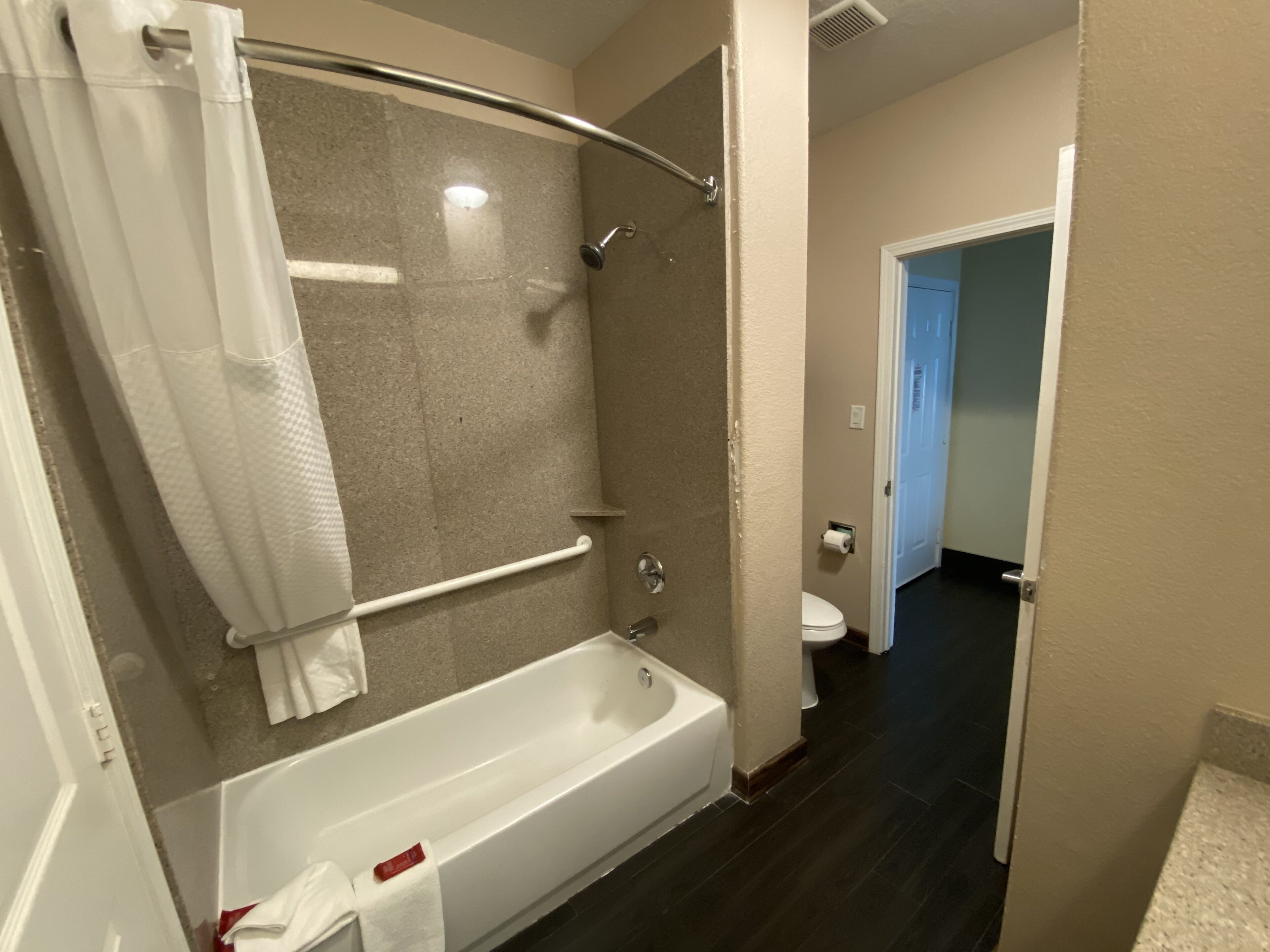 Un baño con bañera, ducha e inodoro.
