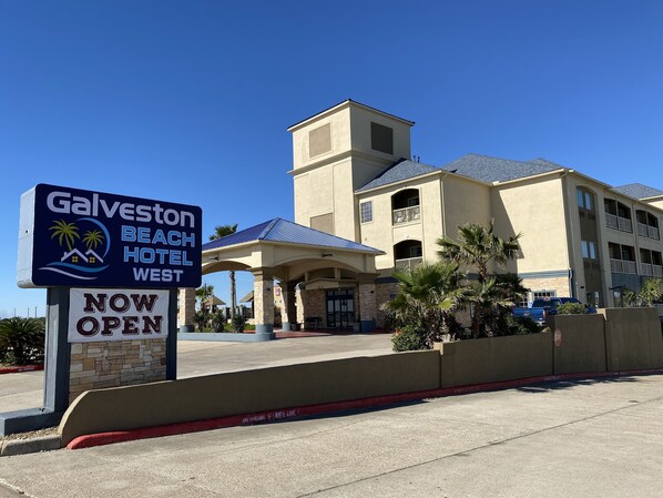 The Galveston Beach Hotel West sign and building facade.
