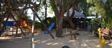 A playground with swings, slides, and a sandpit.