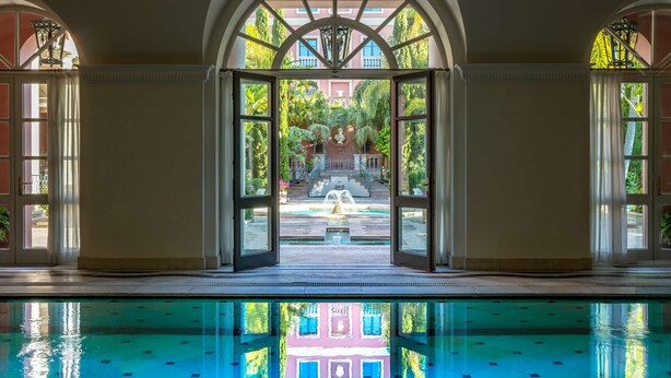 A pool area with a view of a fountain and a building in the background. - Anantara Villa Padierna Palace Benahavís Marbella Resort - A Leading hotel of the world (Benahavis)