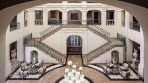 A grand lobby with a central staircase, seating areas, and decorative vases. - Anantara Villa Padierna Palace Benahavís Marbella Resort - A Leading hotel of the world (Benahavis)