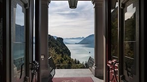Une entrée imposante donnant sur un lac et des montagnes.