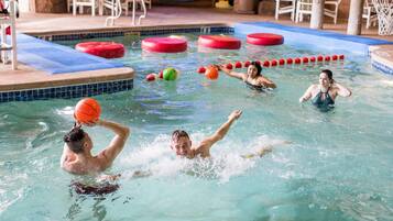Swimmers can enjoy a refreshing dip in the pool surrounded by comfortable seating and amenities.