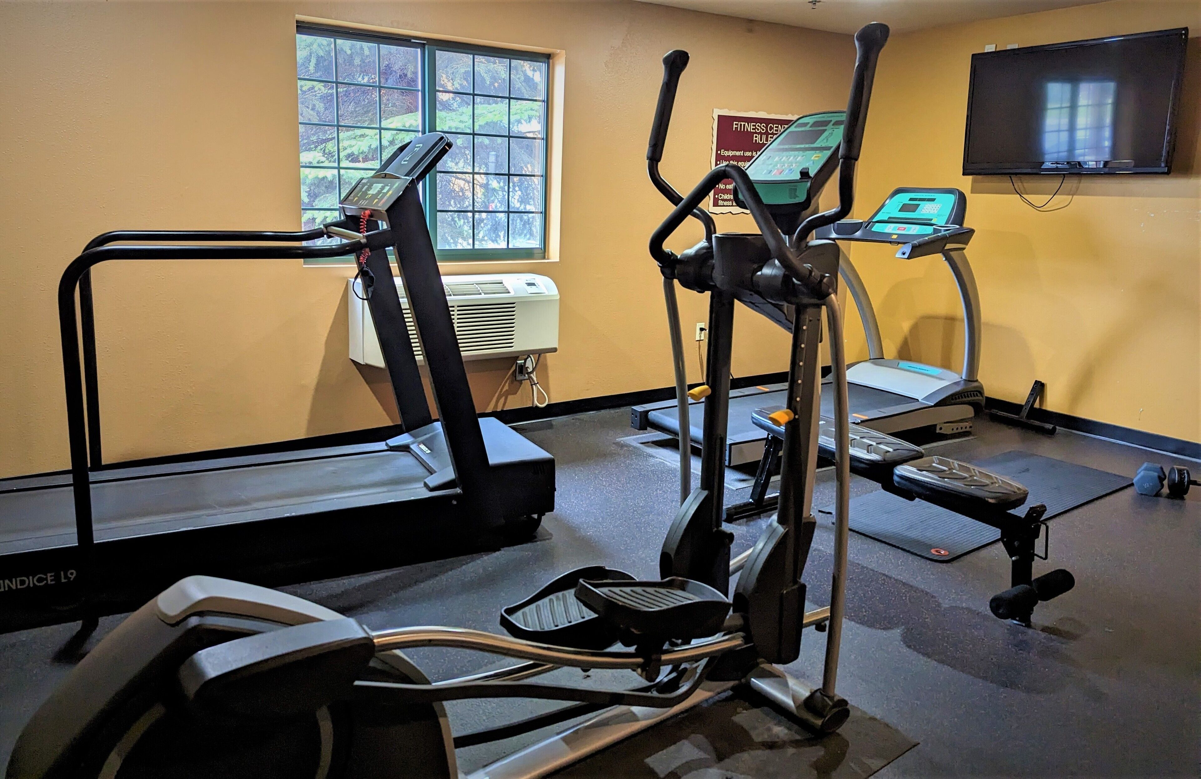 A fitness center with treadmills, an elliptical, and a stationary bike.