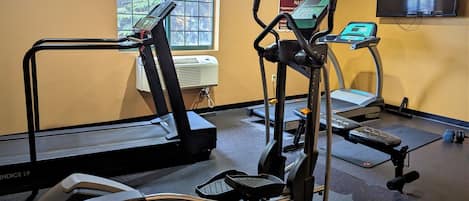 A fitness center with treadmills, an elliptical, and a stationary bike.