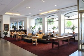 A spacious lobby with a billiards table, comfortable seating, and large windows offering views of the outdoors. - Quality Hotel Park Södertälje City (Sodertalje)