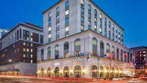 A Courtyard Marriott hotel with a classic architectural style, featuring arched windows and a prominent marquee.