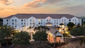 A large, multi-story hotel with a classic architectural design, featuring a central entrance and multiple wings.