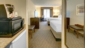 A hotel room with a kitchenette, a bed, a desk, a chair, and a bathroom. - Holiday Inn Express Hotel & Suites Emporia by IHG (Emporia)