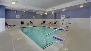 An indoor swimming pool with a blue and white tiled floor, a pool lift, and several lounge chairs around the pool area. - Holiday Inn Express Hotel & Suites Emporia by IHG (Emporia)