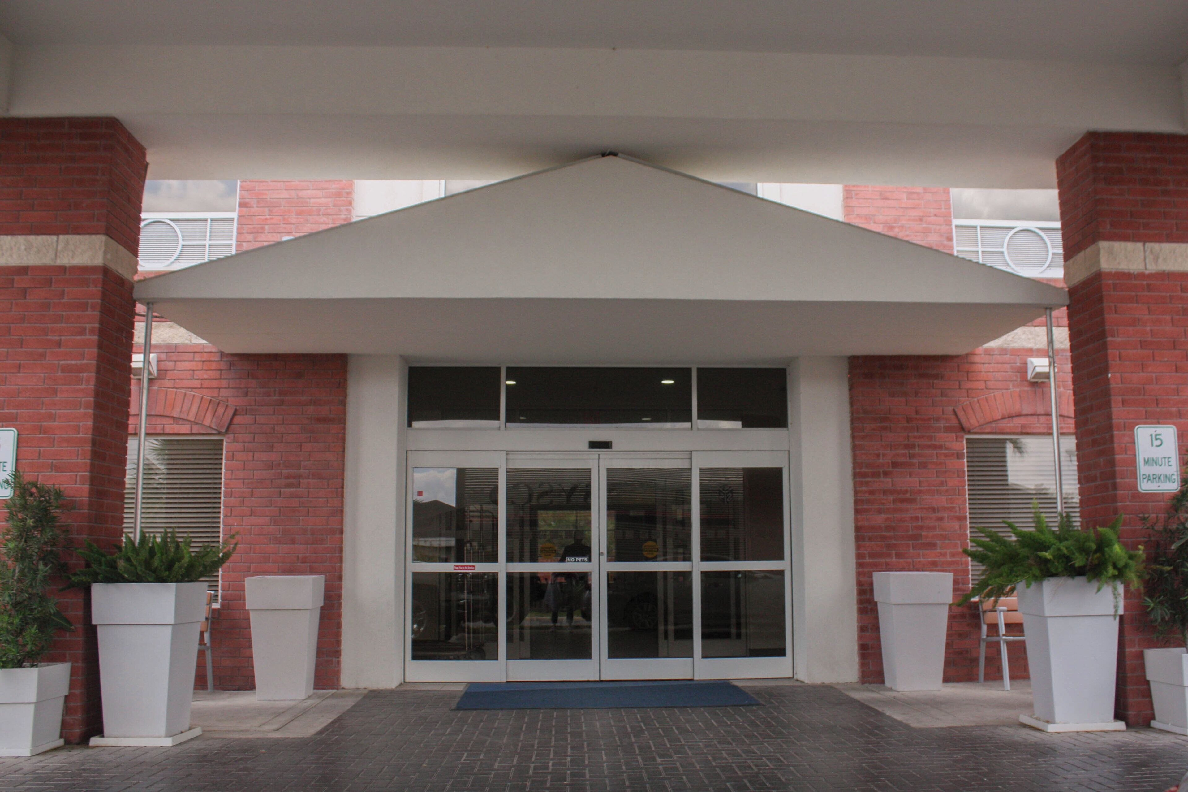 A building entrance with a glass door and a covered area.