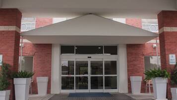 A building entrance with a glass door and a covered area.