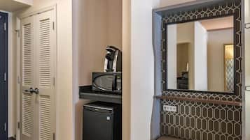 A compact kitchenette with a microwave, coffee maker, and mini-fridge.