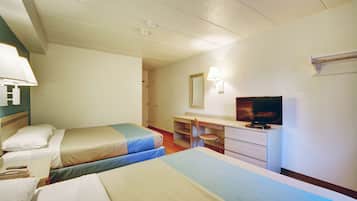 A hotel room with two beds, a desk, a chair, a television, and a mirror.