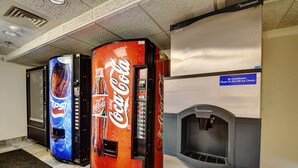 A row of vending machines with Pepsi and Coca-Cola branding, a sign advising against filling ice chests, and a Scotman branded machine. - Motel 6 Newport, RI (Newport)