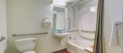 A bathroom with a toilet, sink, and bathtub.