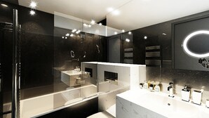 Une salle de bain moderne dotée d’une douche à parois de verre, d’un grand miroir et d’un meuble-lavabo avec plusieurs vasques.
